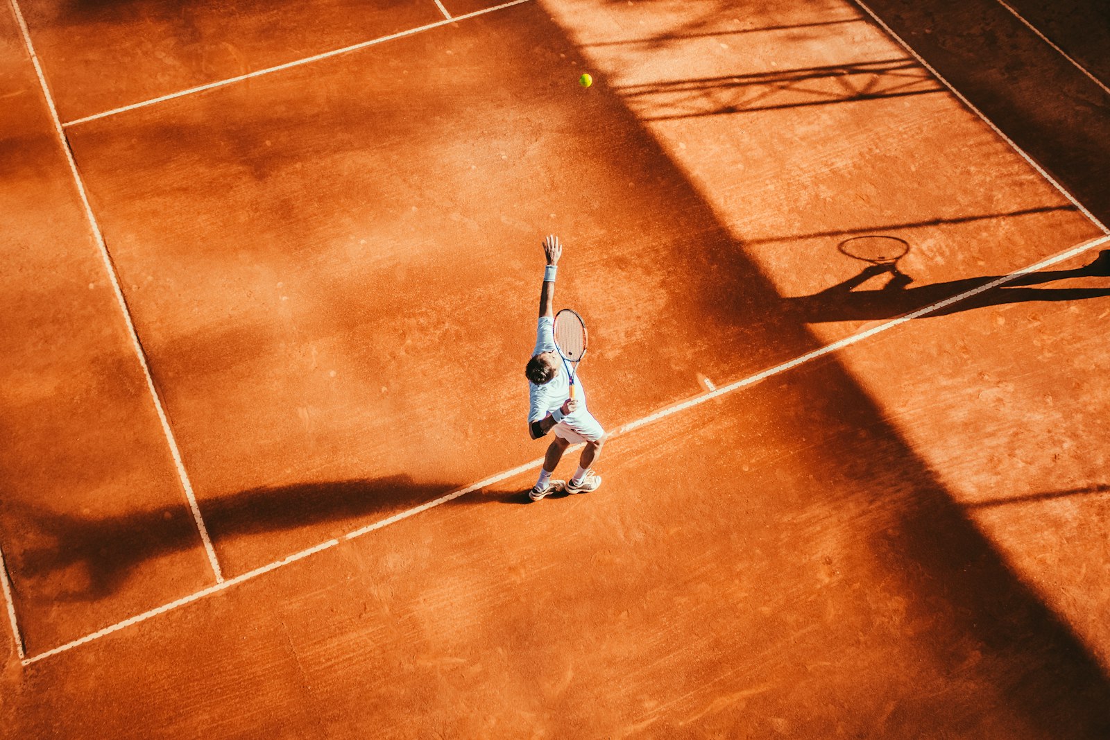Tennisser in actie tijdens een serve.